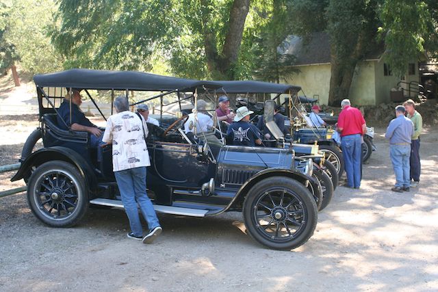 What a line up of old iron, the cars are pretty cool too.