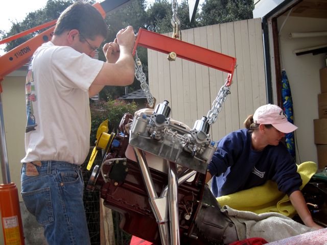 Stuffing the engine and tranny back in.